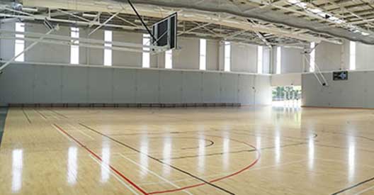Separation of the two courts can be done with a full length drop curtain if required.